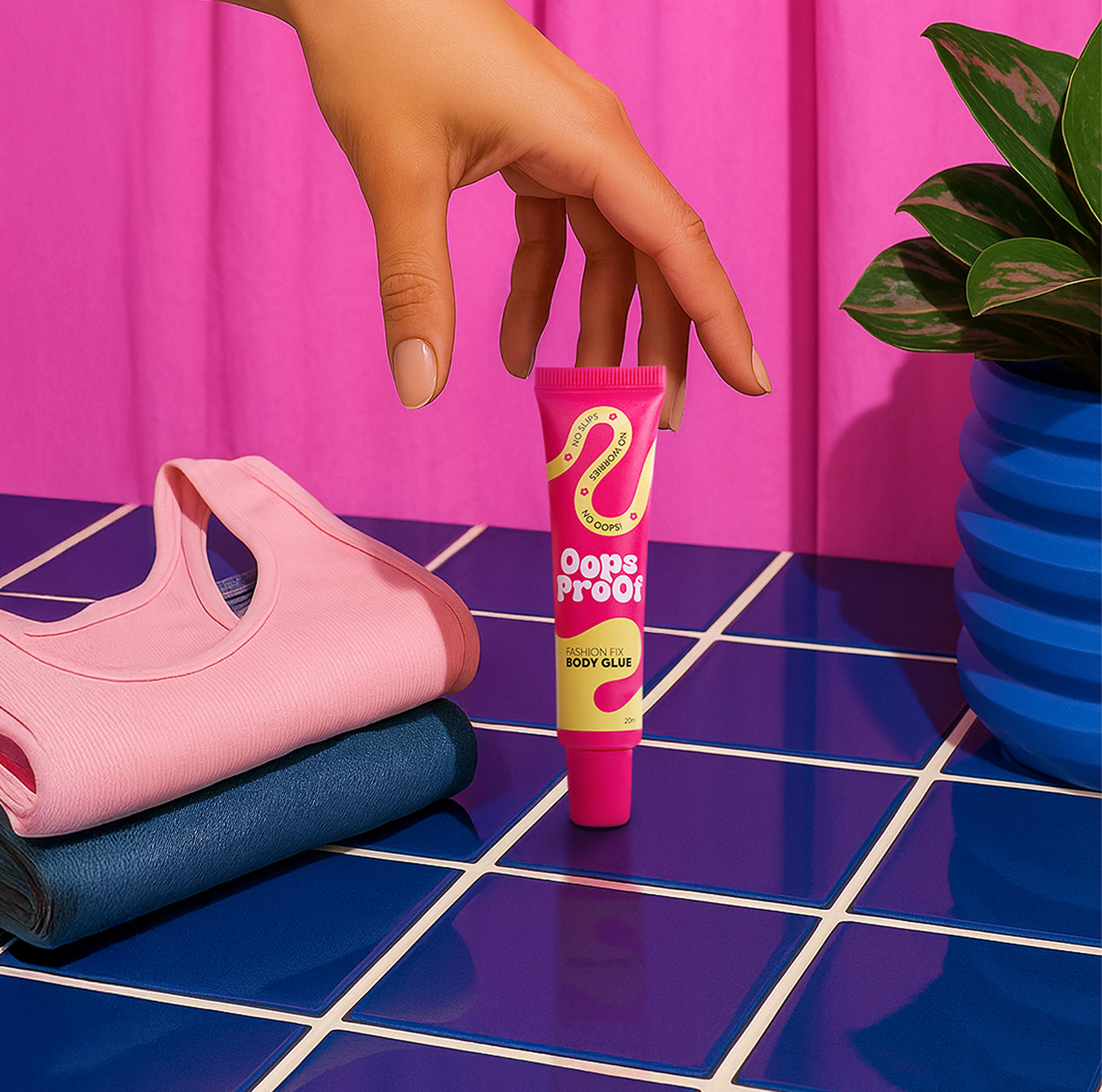 Oops Proof body glue placed beside folded clothes, highlighting it’s skin-safe, odor-free,  travel-friendly and dermatologically tested  . ₹629 price tag.